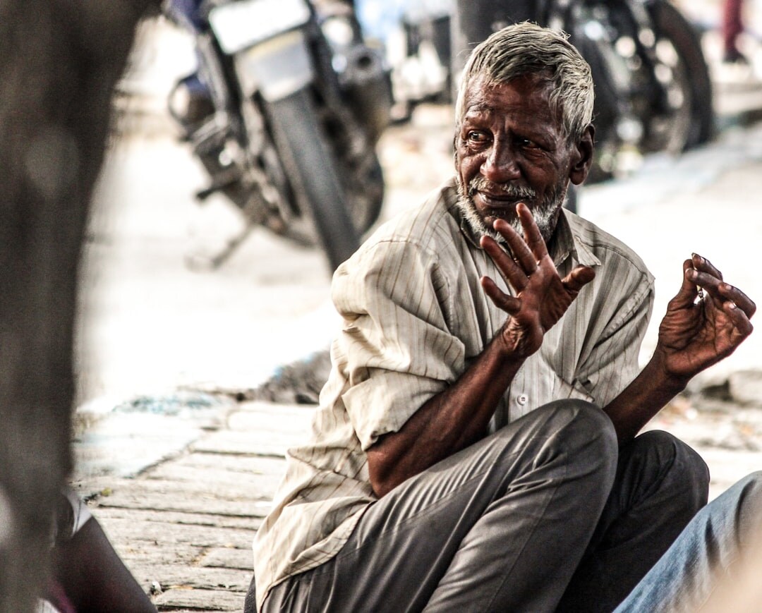 elderly man telling story in street